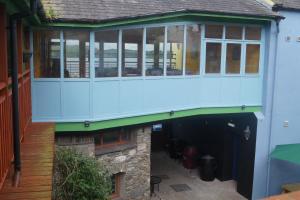 an external view of a house with a deck on top at The Narrows Guesthouse in Portaferry