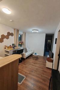a living room with a couch and a table at Basel Access Apart - Habsheim in Habsheim