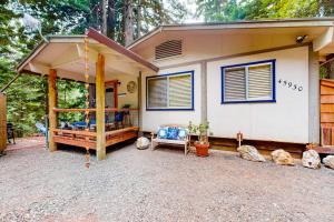 a small house with a porch and a swing at Coastal Cabin in Gualala