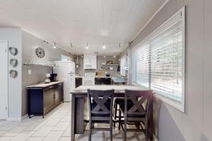 a kitchen with a table and some chairs in it at Coastal Cabin in Gualala