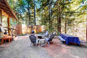 a backyard with a table and chairs and a grill at Coastal Cabin in Gualala +15 photos