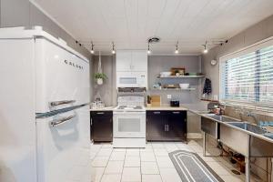 a kitchen with a white refrigerator and a sink at Coastal Cabin in Gualala