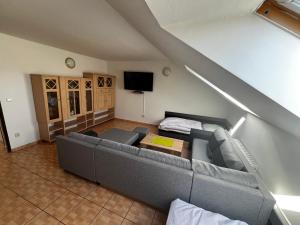 a living room with a couch and a tv at Penzión Dvorec in Dvorec