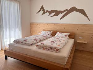 a bedroom with a bed with a bat sign on the wall at Apartment Fidelia in Vandans