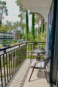a balcony with a table and chairs and a view at Ferre Hotel Shekvetili in Natanebis Sadguri