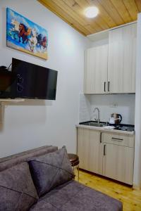 a living room with a couch and a kitchen at Ferre Hotel Shekvetili in Natanebis Sadguri +16 photos