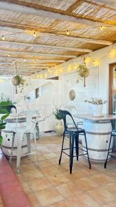 a patio with chairs and a table and a table and chairs at Hotel La Bastide in Le Lavandou