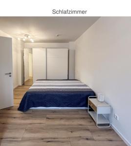 a bedroom with a bed in a white room at Suite Fortuna in Mainz-Kostheim