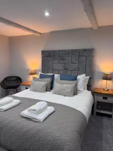 a bedroom with a large bed with towels on it at Last Yan - Stylish Ambleside Stay in Ambleside
