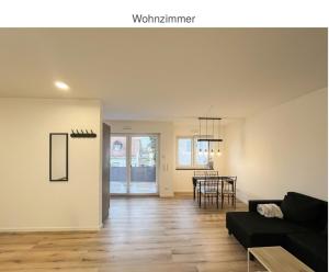 a living room with a couch and a table at Suite Fortuna in Mainz-Kostheim