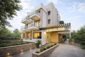 a building with a sign that reads edelman at EMBLEM Hotel - Arjun Marg, Golf Course Road, Gurgaon in Gurgaon