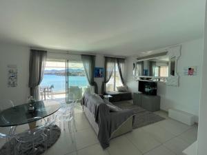 a living room with a couch and a glass table at Appartamento Delfino Bianco in Golfo Aranci