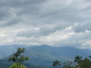 a view of a mountain under a cloudy sky at Vista primavera in Salento