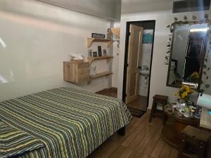 a bedroom with a bed and a table and a mirror at Vista primavera in Salento
