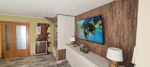 a living room with a television on a wall at Can Tete in Malgrat de Mar