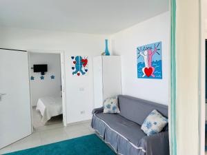 a living room with a gray couch in a room at Appartamento Delfino Bianco in Golfo Aranci