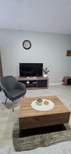a living room with a coffee table and a chair at Apartman Filip in Paraćin +9 photos