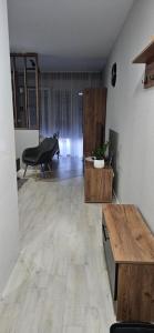 a living room with a table and a piano at Apartman Filip in Paraćin