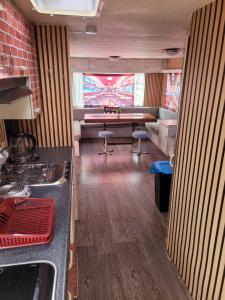 a kitchen with a pool table in the middle of a room at Mobilhome Apartments in Bechhofen