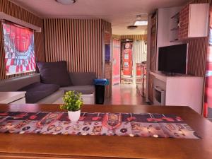 a living room with a couch and a table at Mobilhome Apartments in Bechhofen