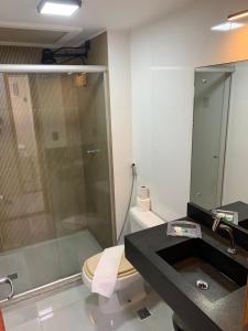 a bathroom with a shower and a toilet and a sink at CJC Short Stay Natal in Natal +25 photos