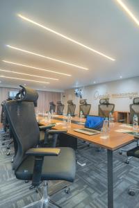 a conference room with a long table and chairs at Karen Plains Hotel Nairobi in Nairobi