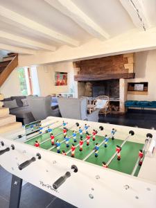 a living room with a pool table and a couch at Maison de famille du 17ème siècle I Proche Senlis Chantilly Compiègne Astérix Paris in Pontpoint