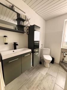 a bathroom with a toilet and a sink at pfefferHÄUSL in Regen +86 photos