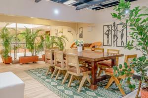 a dining room with a wooden table and chairs at Karen Plains Hotel Nairobi in Nairobi