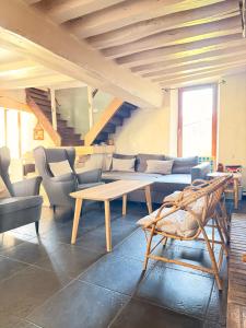 a living room with a couch and a table and chairs at Maison de famille du 17ème siècle I Proche Senlis Chantilly Compiègne Astérix Paris in Pontpoint