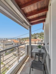 a balcony with a table and chairs and a view at House Seda in Limenas