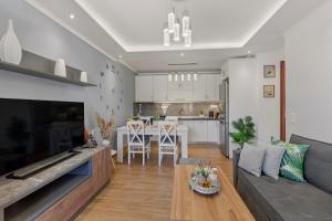 a living room and kitchen with a couch and a table at House Seda in Limenas