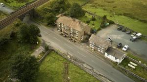 an aerial view of a house with a parking lot at The Station Inn - Ribblehead in Ribblehead Station +20 photos