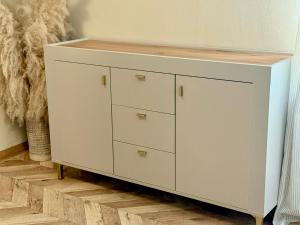 a white cabinet with a wooden counter top on top at Bohemian in Šamorín