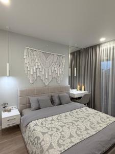 a bedroom with a large bed and a desk at Дивоніч guest house in Kyiv