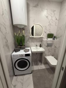a bathroom with a washing machine and a sink at Дивоніч guest house in Kyiv +72 photos