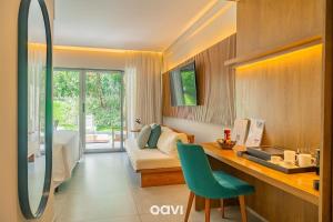 a room with a bed and a desk with a chair at île de Pipa - Ma Plage Hotel in Pipa