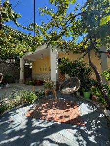 a chair and a table in front of a building at Nika's Guest House in Berat