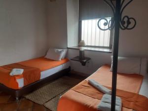 a small room with two beds and a window at La Florida Casona Hotel in Socha