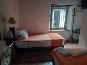 a bedroom with two beds and a window at La Florida Casona Hotel in Socha