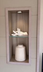 a shelf with a white hat and a white towel at Archerfield Luxe Lodge in Port Seton +63 photos