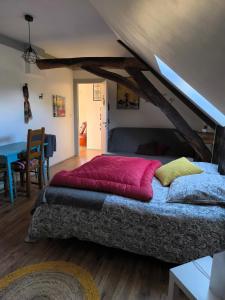 a large bed in a room with a loft at La Bruyère - B & B - in Tréban
