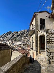 a view of a building with a mountain in the background at La Pietra Gialla in Pietrapertosa