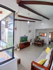 a living room with a couch and a tv at HEYSEN Haus in Tarapoto