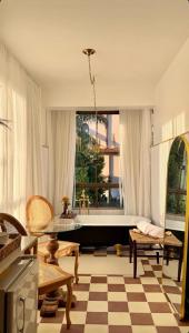 a living room with a pool and a table and chairs at Hotel Ibicui in Rosário do Sul
