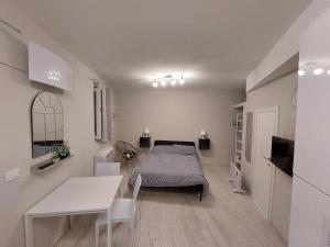 a bedroom with a bed and a table and a desk at La Casetta in Finale Ligure