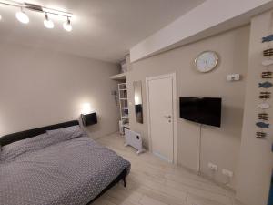 a bedroom with a bed and a clock on the wall at La Casetta in Finale Ligure