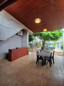 a patio with a table and chairs on it at HEYSEN Haus in Tarapoto