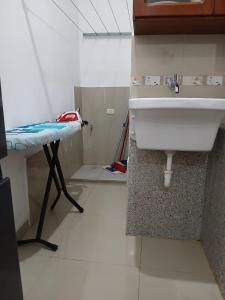 a kitchen with a sink and a table in a room at HEYSEN Haus in Tarapoto +84 photos