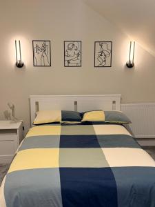 a bedroom with a bed with three pictures on the wall at Birch view getaway in Dunshaughlin +8 photos